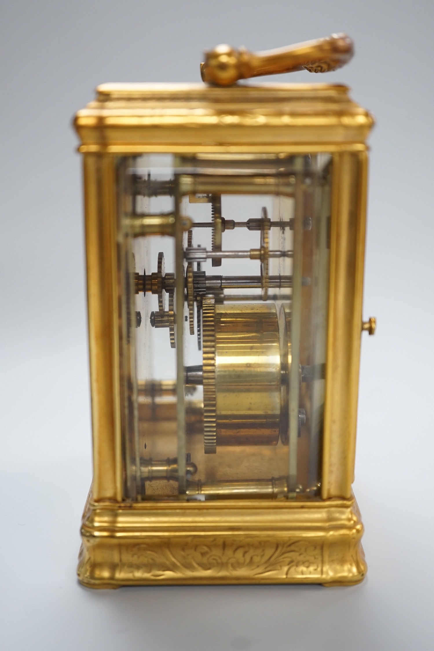 A late 19th century French eight day timepiece, in an engraved brass gorge case. 12cm tall
